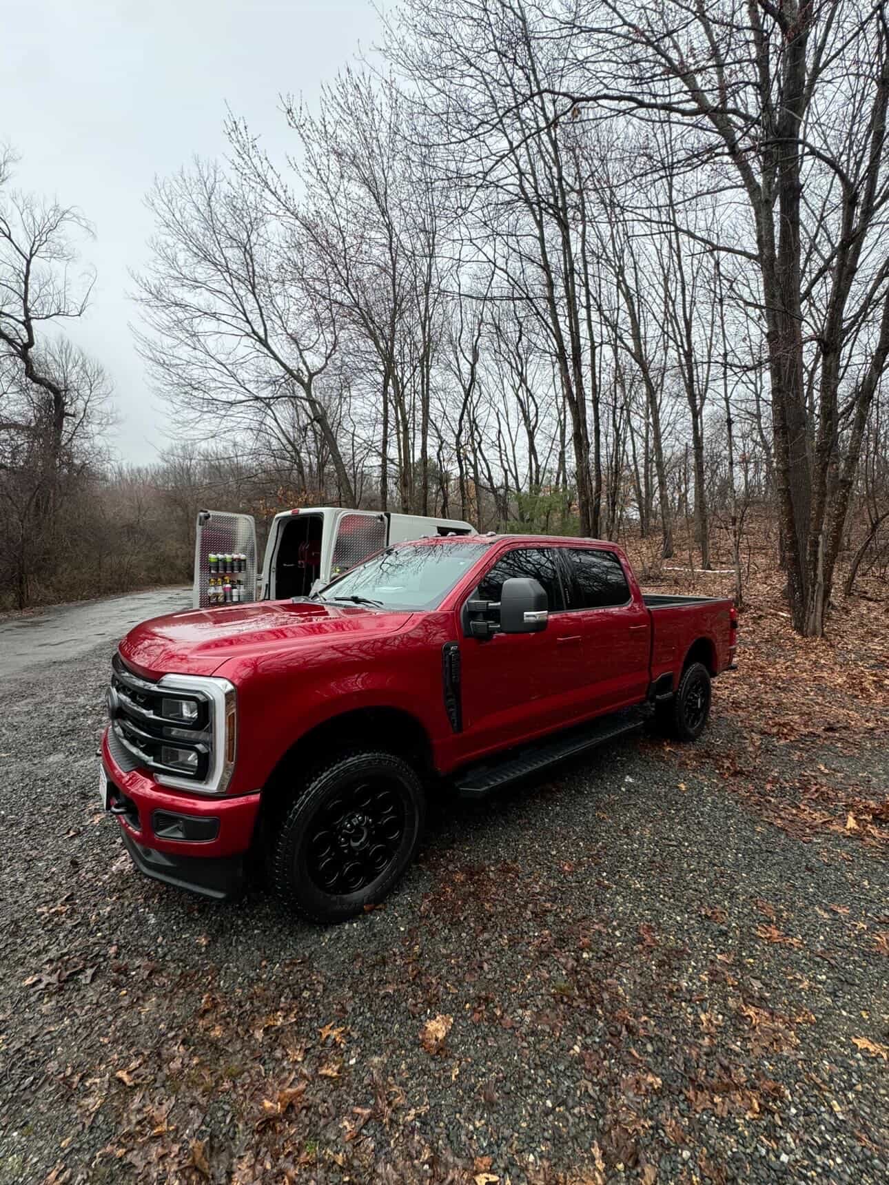 Red Ford F-250 Super Duty covered in foam during exterior wash